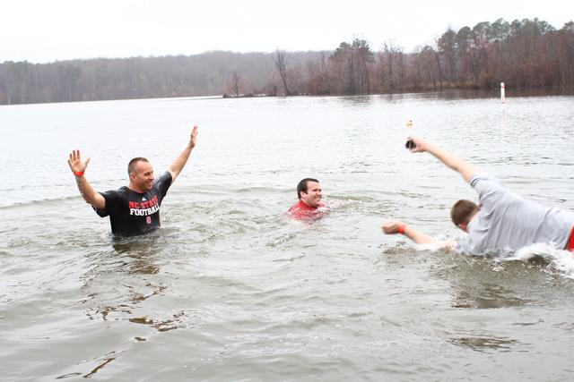 N.C. State Head Football Coach Dave Doeren hangs out in the water after casually walking in the chilly water of Lake Raleigh during the N.C. State Polar Plunge February 23, 2013. Photo by Katherine Hoke