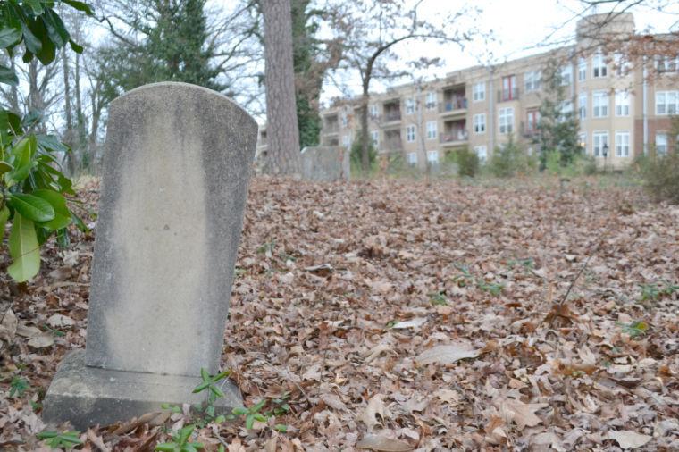A weatherd headstone stands solemnly in the Oberlin Village Cemetery just north of Cameron Village behind the InterAct building Feb. 25, 2013. The 140-year-old burial ground was recently approved by the Raleigh City Council to be added to the list of Raleigh Historic Landmarks because of its significance to black history in Wake County. Photo by Caide Wooten.