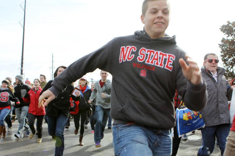 N.C. State students sprinting across the Carter-Finley/PNC Arena property in attempt to be the first people in line for the UNC Chapel Hill game.
