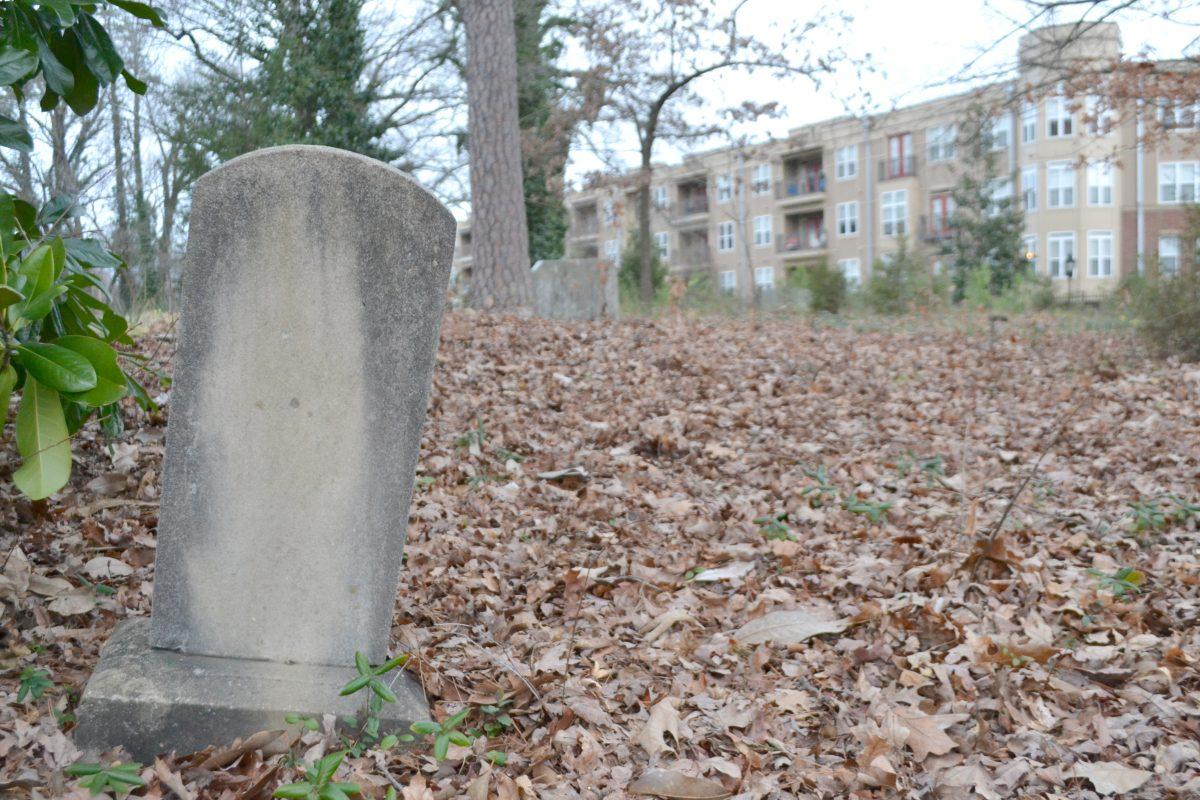 A weatherd headstone stands solemnly in the Oberlin Village Cemetery just north of Cameron Village behind the InterAct building Feb. 25, 2013. The 140-year-old burial ground was recently approved by the Raleigh City Council to be added to the list of Raleigh Historic Landmarks because of its significance to black history in Wake County. Photo by Caide Wooten.