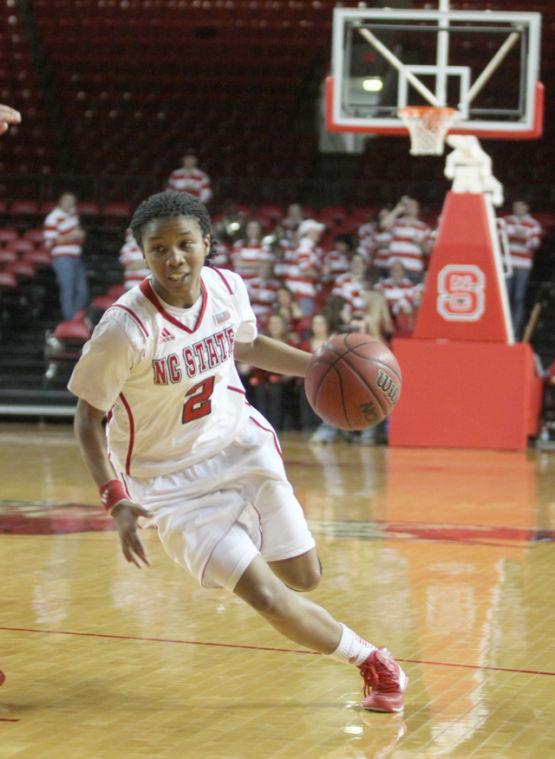 Len'Nique Brown drives past a Richmond defender. The Wolfpack ladies toppled Richmond 60-55 Thursday evening March 21, 2013 in Reynolds Coliseum to advance to the second round of the WNIT. Photo by Patrick Whaley.