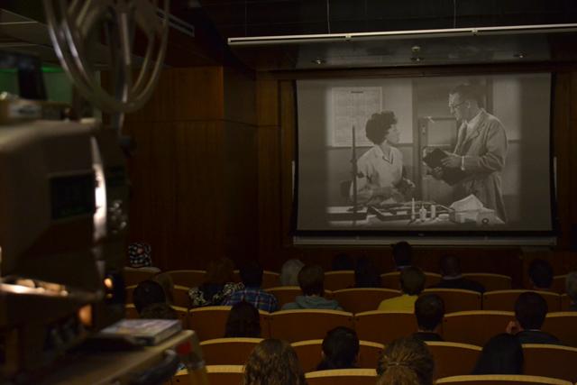 Students watch a 1960's short film about women in the workplace in the D.H. Hill auditorium Tuesday, March 26, 2013. The 16mm film was shown as a part of the A/V Geeks' presentation, "The Trouble with Women."&#160;