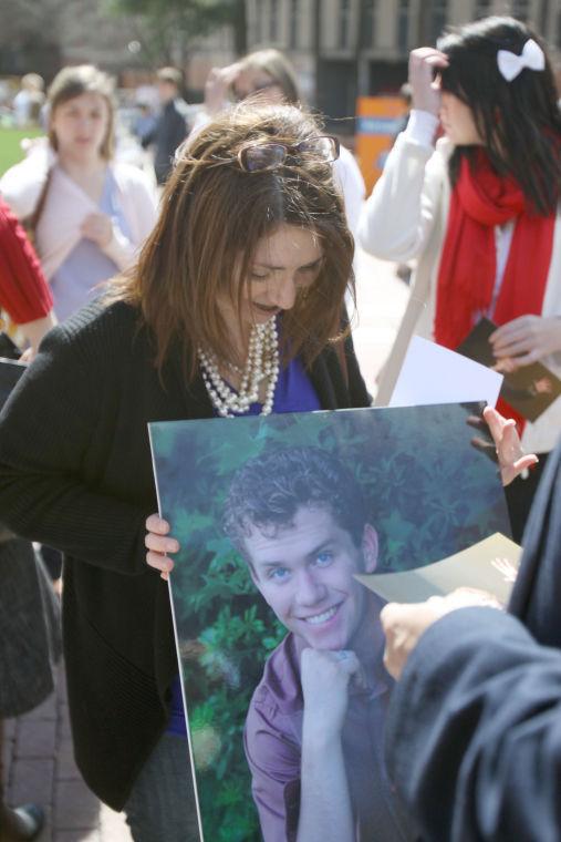 Cindy Peterson, mother of Ian Peterson, holds a photo of her son during a memorial event on the Brickyard Wednesday, March 13. Ian Peterson died&#160; Feb. 27 after a five-month battle with cancer.