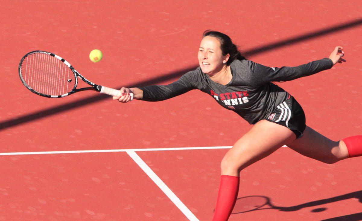 Sophomore tennis player Sophie Nelson returns a volley at the net in a doubles match with senior Chloe Smith against UVA on Tuesday March 14 at Dail Outdoor Tennis Stadium. Nelson and Smith lost the match 8-6. Photo by Katherine Hoke