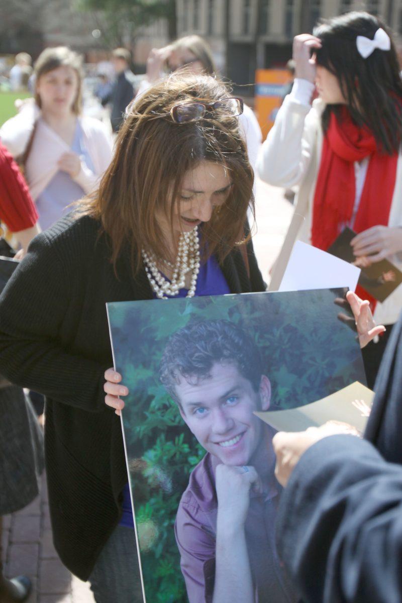 Cindy Peterson, mother of Ian Peterson, holds a photo of her son during a memorial event on the Brickyard Wednesday, March 13. Ian Peterson died&#160; Feb. 27 after a five-month battle with cancer.