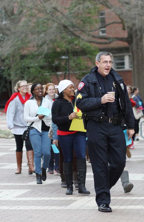 Sergeant Bill Davis of the NCSU Police Department leads a march to Witherspoon Student Center during the Take Back the Night event Monday evening March 25, 2013. Sergeant Davis later spoke as one of the welcome speakers during the event after the march.