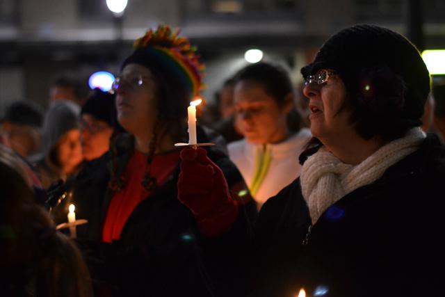 An attendant of the marriage equality vigil holds a candle aloft at the Wake County Courthouse Tuesday evening, March 26, 2013. The vigil was held in celebration of the fact that the Supreme Court is currently judging the constitutionality of California's Proposition 8 and the Defense of Marriage Act, both of which limit the recognition of same-sex marriages.