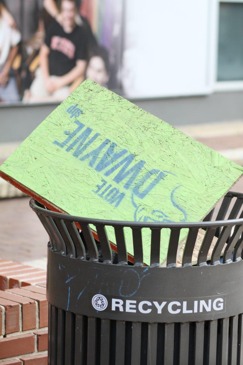 A Dwayne O'Rear campaign sign lies discarded in a recycling bin near Harrelson Hall Monday evening, March 25, 2013.