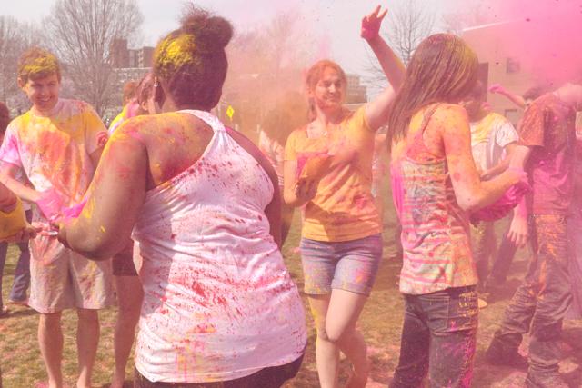 Freshman in biology Cassie Brinkman partake in the Hindu festival Holi on Harris Field Saturday.