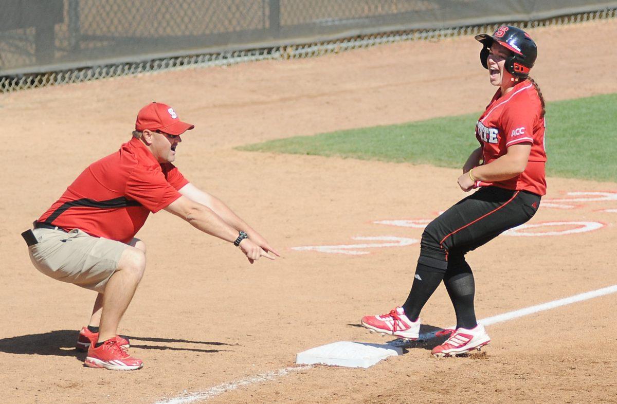 Senior outfielder Bethaney Wells screams as she stops at third base after a double by N.C. State against North Carolina Saturday, April 13, 2013. Wells went 1-for-3 with 2 earned runs in the Wolfpack's 11-8 win against the Tar Heels at Dail Stadium. Photo by Ryan Parry.