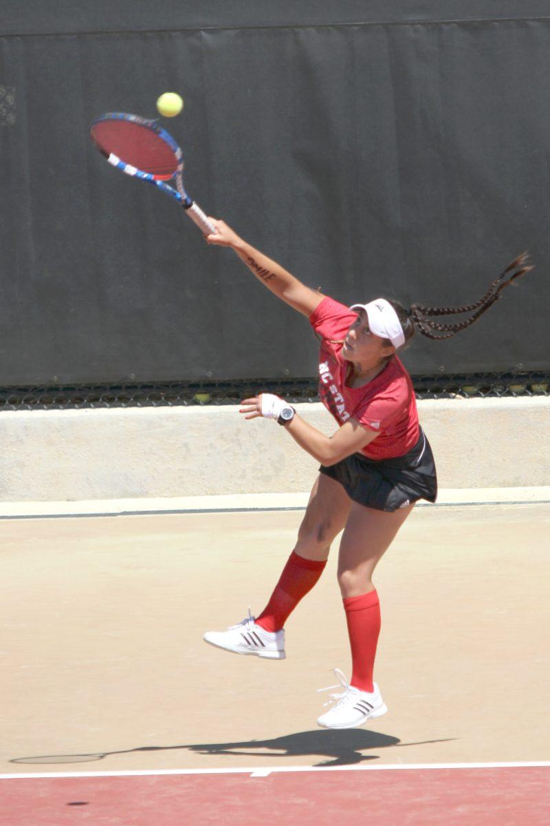 Sophomore Nicole Martinez serves in her doubles match with Elisha Hande against Boston College April 13, 2013 at the Curtis &amp; Jacqueline Dail Outdoor Tennis Stadium. The Wolfpack defeated the Eagles 5-2 on Saturday and the Maryland Terrapins 7-0 on Sunday, bringing them to 4-5 in the ACC and 13-6 overall. Photo by Caide Wooten.