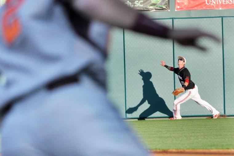 Sophomore infielder Jake Armstrong attempts to catch a fly ball during the game against Virginia Tech, Friday April 5, 2013. The Wolfpack battled the Hokies for six scoreless innings to a victory of 8-7 in the fourteenth inning, and went on to win all three games in the weekend series.