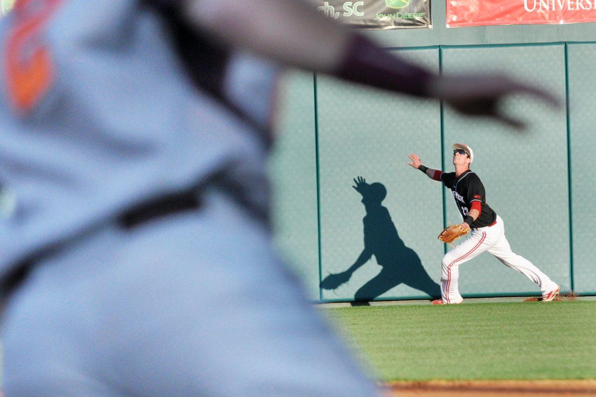 Sophomore infielder Jake Armstrong attempts to catch a fly ball during the game against Virginia Tech, Friday April 5, 2013. The Wolfpack battled the Hokies for six scoreless innings to a victory of 8-7 in the fourteenth inning, and went on to win all three games in the weekend series.