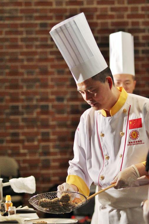 Chef Lin Chaodai, senior chef and nutritionist, prepares a dish at A Bite of China, an event provided by the China Cuisine Association and Confucius Institute Wednesday, April 17 2013. Four chefs gave demonstrations after a presentation in Bostian hall, where guests were allowed to ask questions and taste the food.