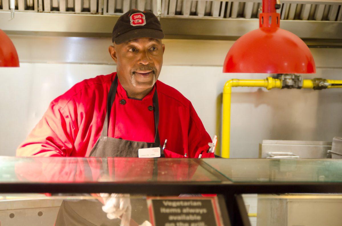 Charles Lark speaks with a student in Clark Dining Hall Thursday, April 25, 2013. Photo by John Joyner.