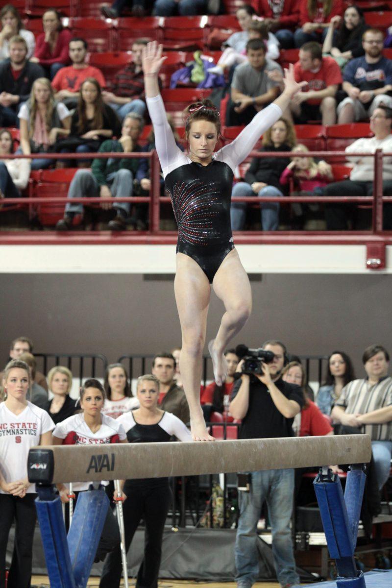 Photo by Joannah Irvin. Junior gymnast Heidi Ffield competes on the beam against Maryland on Jan. 11. The Wolfpack brought their season to a close this weekend, placing fifth at the NCAA Regional Competition in Columbus, Ohio.
