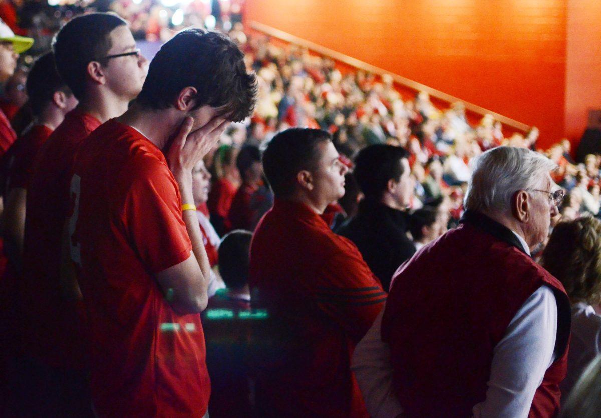 Greg Moore, a junior in sport management, holds his hands over his face after N.C. State fell to Temple during the second round of the NCAA Tournament at the University of Dayton Friday, March 22, 2013. The Wolfpack fell to the Owls 76-72 in Dayton, Ohio. Photo by Ryan Parry.