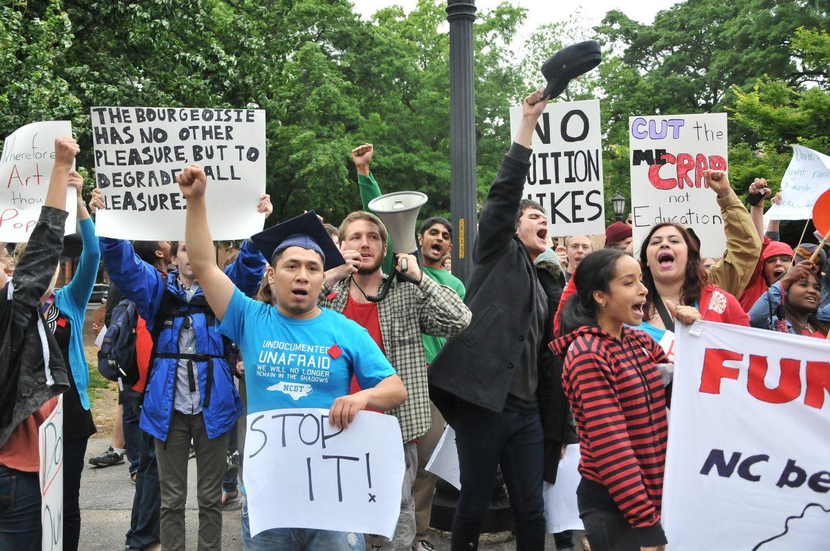 Students of the N.C. Student Power Union walk through Moore Square in downtown Raleigh on May Day, May 1, 2013, to protest the propsoed cuts to public education and services. Photo by Ryan Parry.