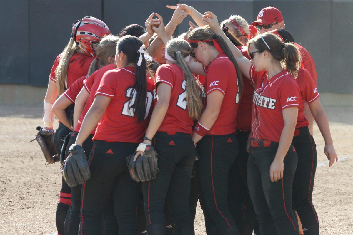 The N.C. State softball team huddles up before taking the field during the second game of the three-game series against UNC April 13, 2013 at the Curtis &amp; Jacqueline Dail Softball Stadium. The Wolfpack took the series 2-1, taking them to 7-7 in the ACC and 23-18-1 overall. Photo by Caide Wooten.