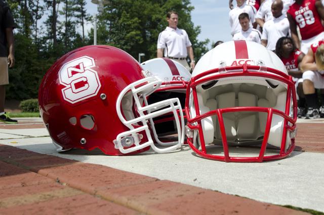The new red helmets were displayed, along with the white helmets from last season, at the 2012 football media day on August 11. Photo by Charlie Harless.