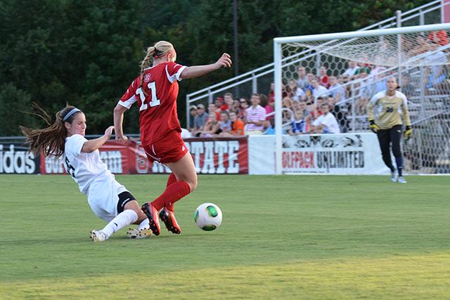 Sophomore forward Brittany Stanko works to maintain possession of the ball during the soccer match against Longwood in Dail Soccer Stadium Sunday Aug. 25, 2013. The Wolfpack pulled out a 3-2 victory over the Lancers in the closing minutes of the game. Photo by John Joyner.
