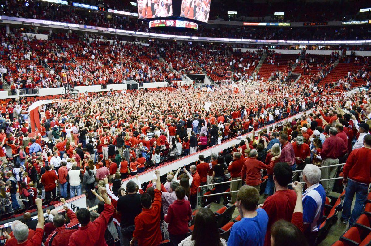 Fans celebrate on the court after defeating Duke in PNC Arena Saturday, Jan. 12, 2013. The No. 20 Wolfpack defeated the No. 1 Blue Devils 84-76. Photo by John Joyner.