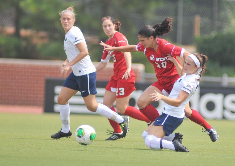 Freshman forward Jackie Stengel fights for possession of the ball against an East Tennessee State University player Sunday, September 1, 2013. The Wolfpack defeated the Buccaneers 3-0 at Dail Soccer Field.