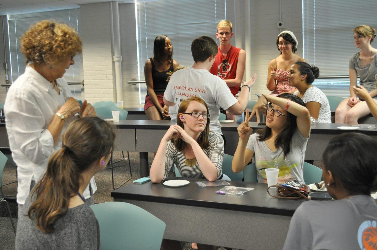 The American Sign Language Club holds its first meeting in Daniels Hall, on Tuesday, September 10, 2013. The meeting challenged students to do multiple without talking to each other. Their only way of communication was hand motions.