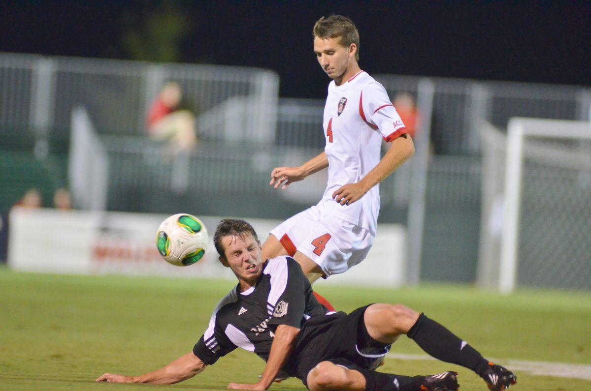 Freshman midfielder Yanni Hachem moves the ball past a fallen defender during soccer match against new Davidson at Dail Soccer Field Tuesday, Sept. 24, 2013. The Wolfpack defeated the Wildcats 2-0.