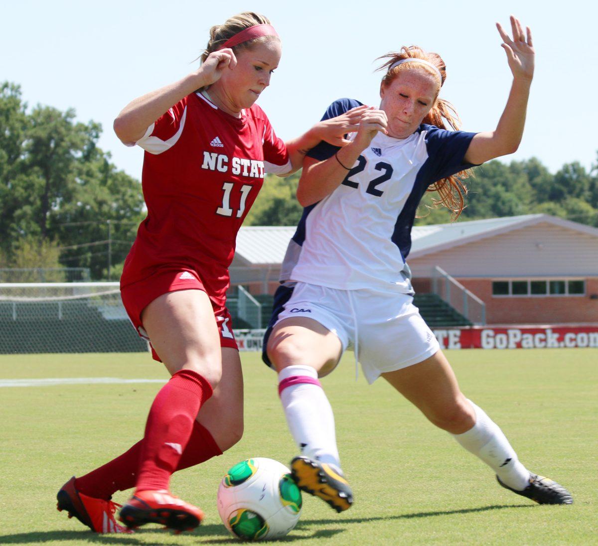 Sophomore forward Brittany Stanko and Seahawk defender fight for possession of the ball. Stanko scored two goals in the Wolfpack 2-1 win against UNC - Wilminbton Sunday, Sept. 8, 2013 at Dail Soccer Field. Photo by Sam Whitlock