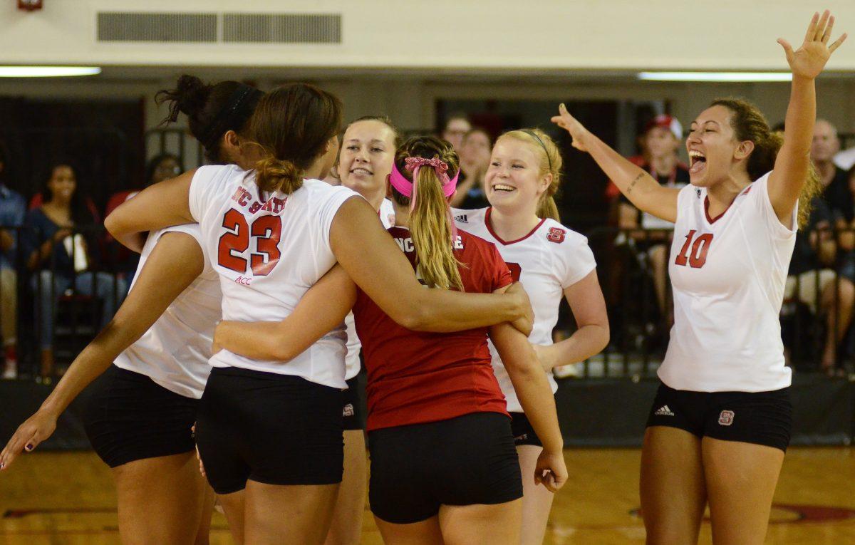 The N.C. State volleyball team celebrate after scoring a point against Apalachian State Friday, September 6, 2013. The Wolfpack defeated the Mountaineers 3-0 during the first game of the Courtyard Midtown Classic at Reynolds Coliseum.
