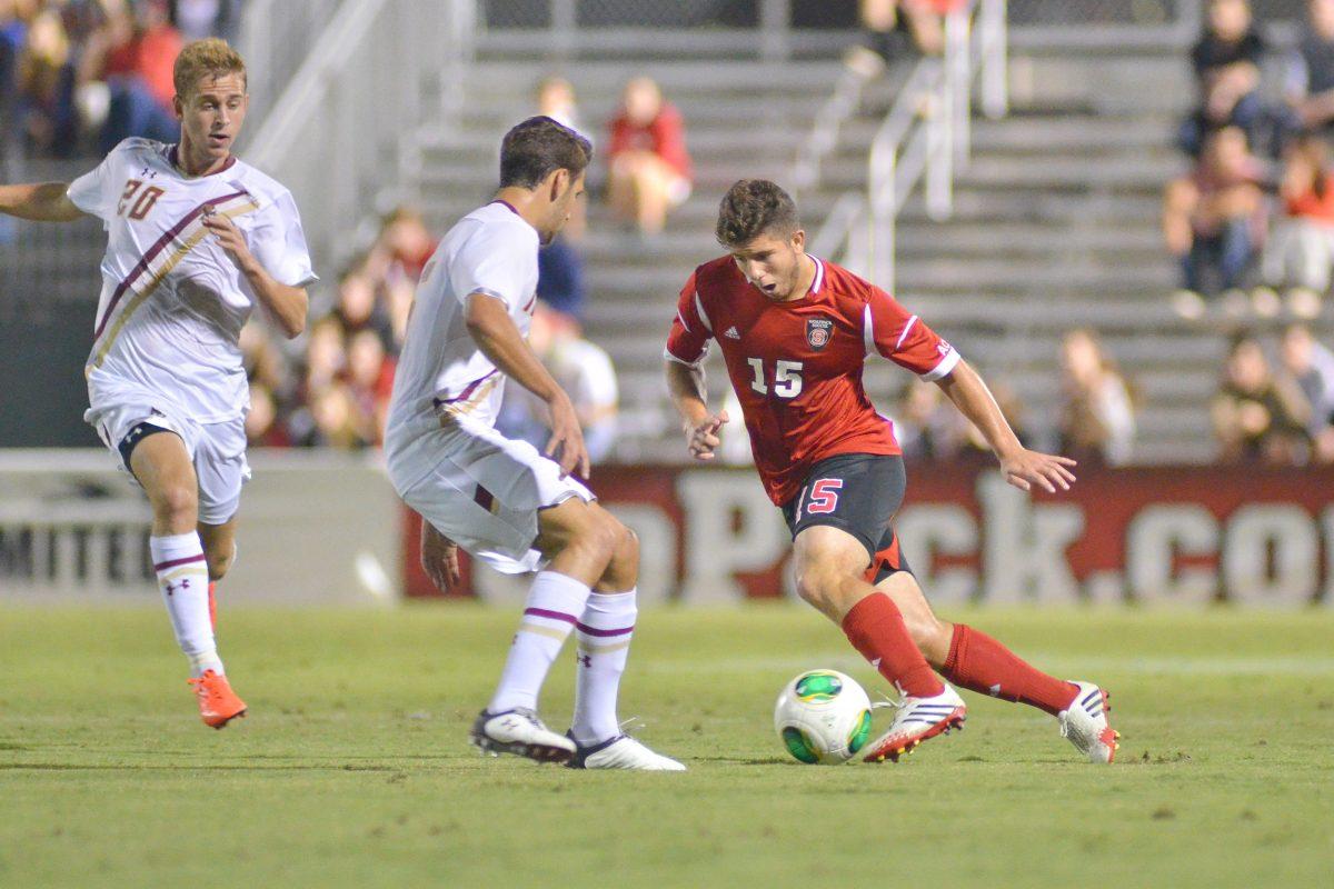 Senior midfielder Alex Martinez drives down the pitch during soccer match against Boston College at Dail Soccer Field Tuesday, Sept. 27, 2013. The Wolfpack fell to the Eagles 2-1. Photo by John Joyner.