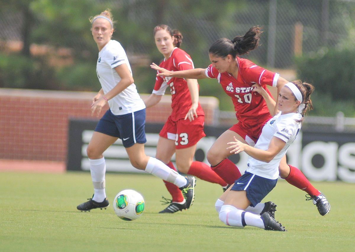 Freshman forward Jackie Stengel fights for possession of the ball against an East Tennessee State University player Sunday, September 1, 2013. The Wolfpack defeated the Buccaneers 3-0 at Dail Soccer Field.