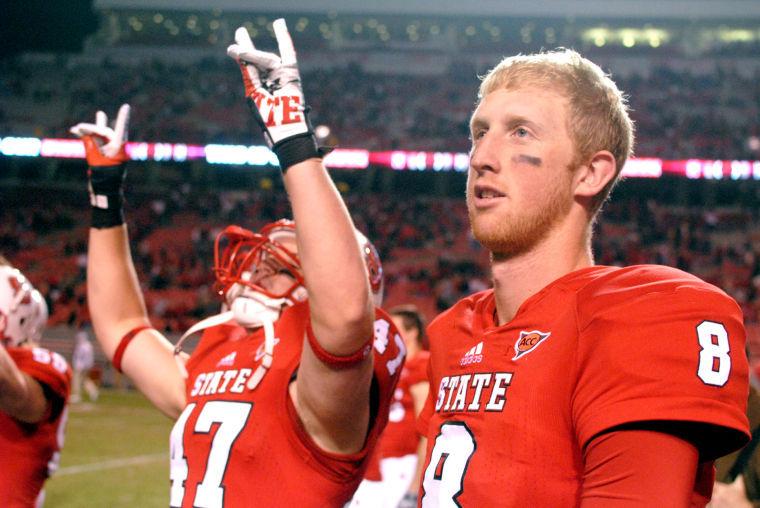 Former quarterback Mike Glennon and redshirt junior fullback Tyler Purvis walk toward the student section after a 37-6 win over Wake Forest at Carter-Finley Stadium. Glennon had 258 total yards in the Wolfpack's win Saturday, Nov. 10, 2012.