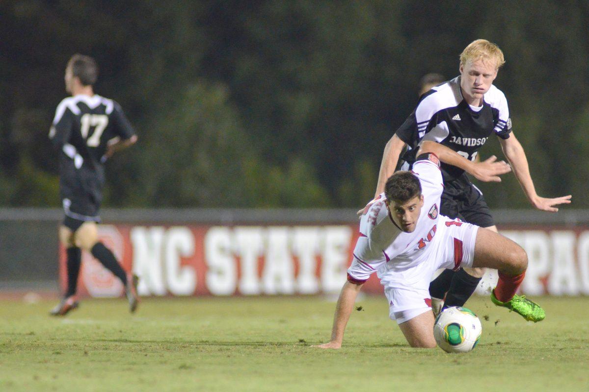 Senior midfielder Nazmi Albadawi slips to the ground during soccer match against new Davidson at Dail Soccer Field Tuesday, Sept. 24, 2013. The Wolfpack defeated the Wildcats 2-0.