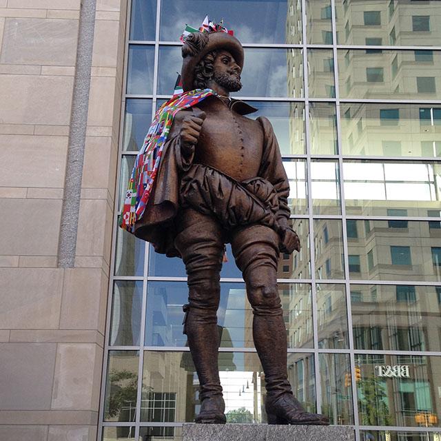  
The statue of Sir Walter Raleigh stands outside of the Raleigh Convention Center. Organizers of the International Festival adorned him with a cape made up of different countries’ flags and stuck flags in his hat, as well.
