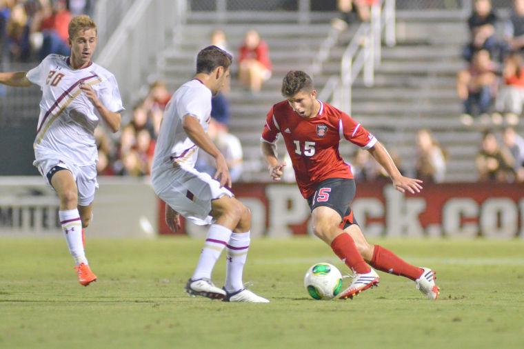 Senior midfielder Alex Martinez drives down the pitch during soccer match against Boston College at Dail Soccer Field Tuesday, Sept. 27, 2013. The Wolfpack fell to the Eagles 2-1.