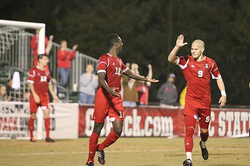 Redshirt junior forward Nick Surkamp celebrates with junior defender Moss Jackson-Atogi, after Atogi scored his first goal of the season on the Appalachian State goalie. The Wolfpack beat the Mountaineers 4-1 Tuesday at Dail Soccer Field.