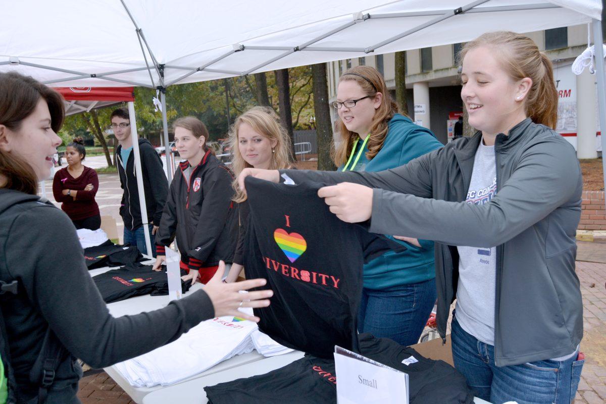 Lindsay Jones, a sophomore in biopprocessing sciences, volunteers with Women's Rugby by handing out "I [Heart] Diversity" T-Shirts to NC State students in the brickyard as part of I [Heart] Diversity Week on Monday.
