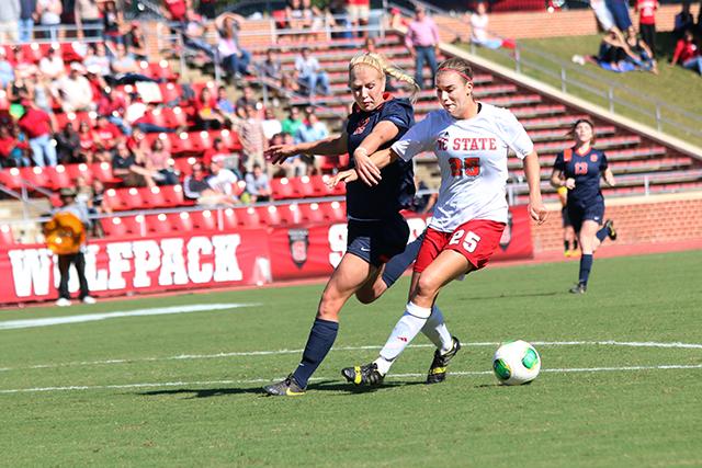 Sophomore forward, Caroline Gentry blocks Syracuse defender from the ball at Dail Soccer Field. Gentry had an assist to freshman forward, Jackie Stengel Sunday, October, 20, 2013.
