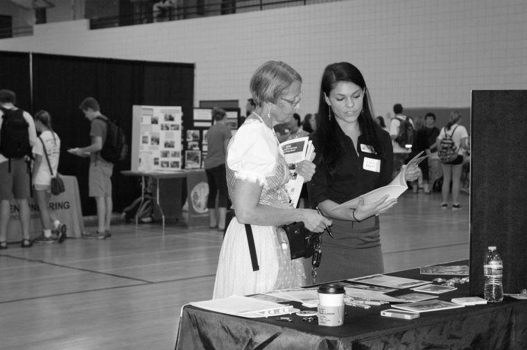 Mary Margaret Elmayan speaks with a representative about the Peace Corps at the Study Abroad Fair Friday, 4 Oct. 2013. At the fair, there are booths for countries from all over the world and for NCSU colleges. Students can easily find major-specific or country-specific programs. Photo by Karin Eriksson.