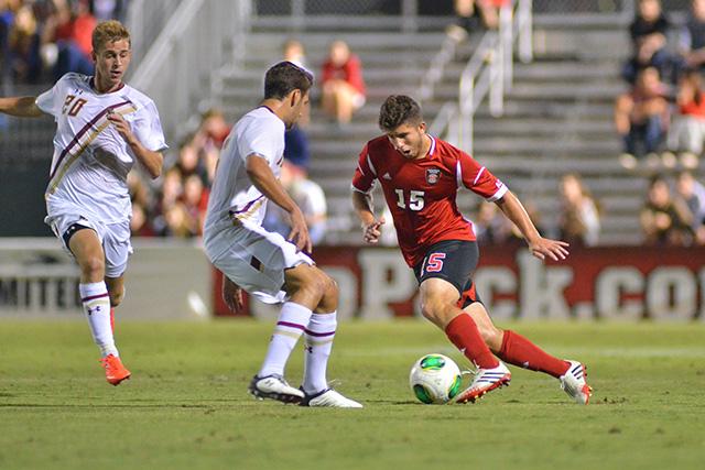 Senior midfielder Alex Martinez drives down the pitch during soccer match against Boston College at Dail Soccer Field Tuesday, Sept. 27, 2013. The Wolfpack fell to the Eagles 2-1. Photo by John Joyner.