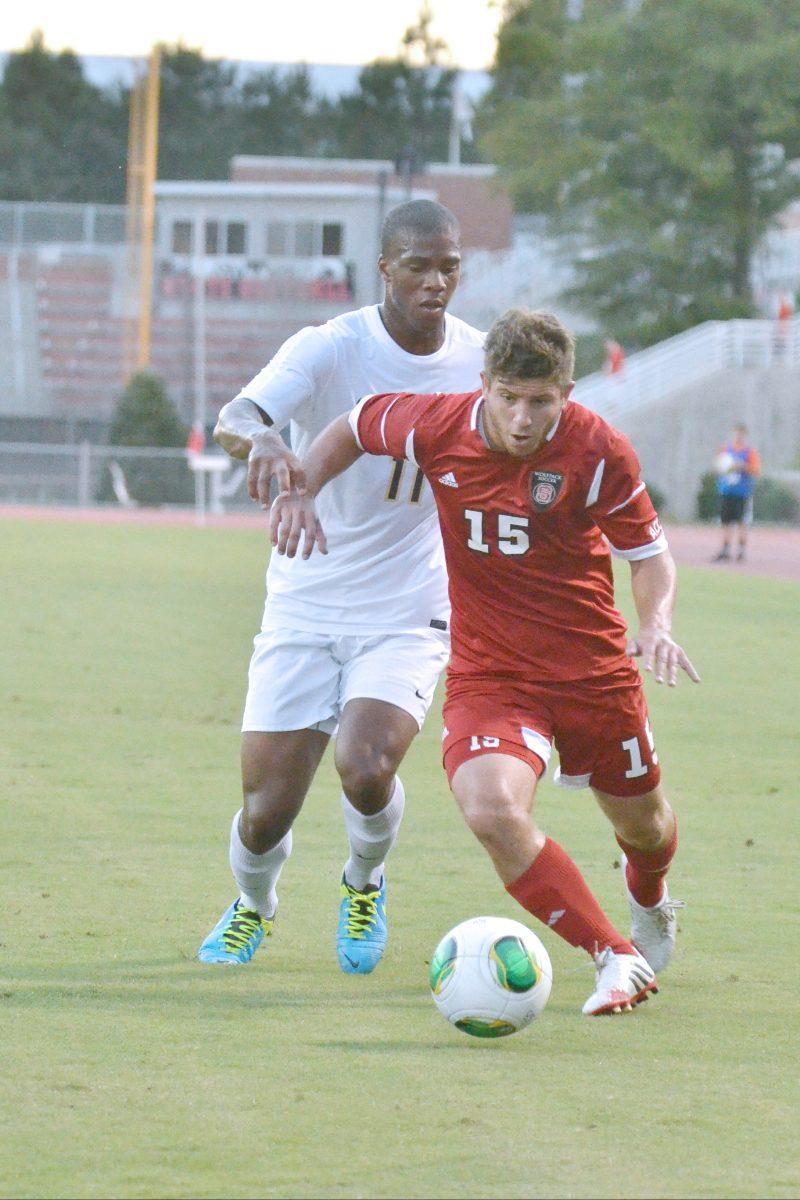 Senior midfielder Alex Martinez drives past a defender towards the goal during the conference opening soccer match against new ACC member Pittsburgh at Dail Soccer Field Friday, Sept. 6, 2013. The Wolfpack defeated the Panthers 1-0 in overtime.