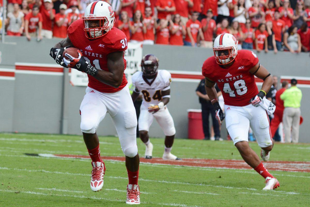 Senior linebacker D.J. Green runs the ball Saturday, Sept. 28, 2013 at Carter-Finley Stadium against Central Michigan. Green returned the interception for a touchdown. The Wolfpack defeated the Chippewas 48-14 after holding them scoreless until the 4th quarter. Photo by Chris Rupert