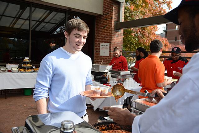 Receiving a sample of the Chili Chili Bang Bang from Fountain Dining Hall chef, freshman business major Patrick Cartwright prepares to pick which chili he thinks is the best Thursday, Oct. 31, 2013. Case Dining Hall hosted their anual chili challenge where cooks from each of the seperate dining halls compete with their homemade chilis. Students sampled the different ones and chose the winner through voting with a wooden chip. Photo by Joseph Phillips