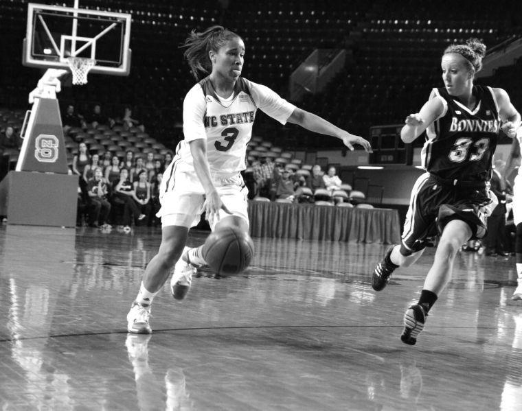 Charging forward, freshman guard Miah Spencer runs down the court for a layup against opposing St. Bonaventure sophomore Emily Michael. The women's basketball team beat the Bonnies 70-47 in Reynolds Coliseum Friday, Nov. 8, 2013 during the season opener. Photo by Joseph Phillips