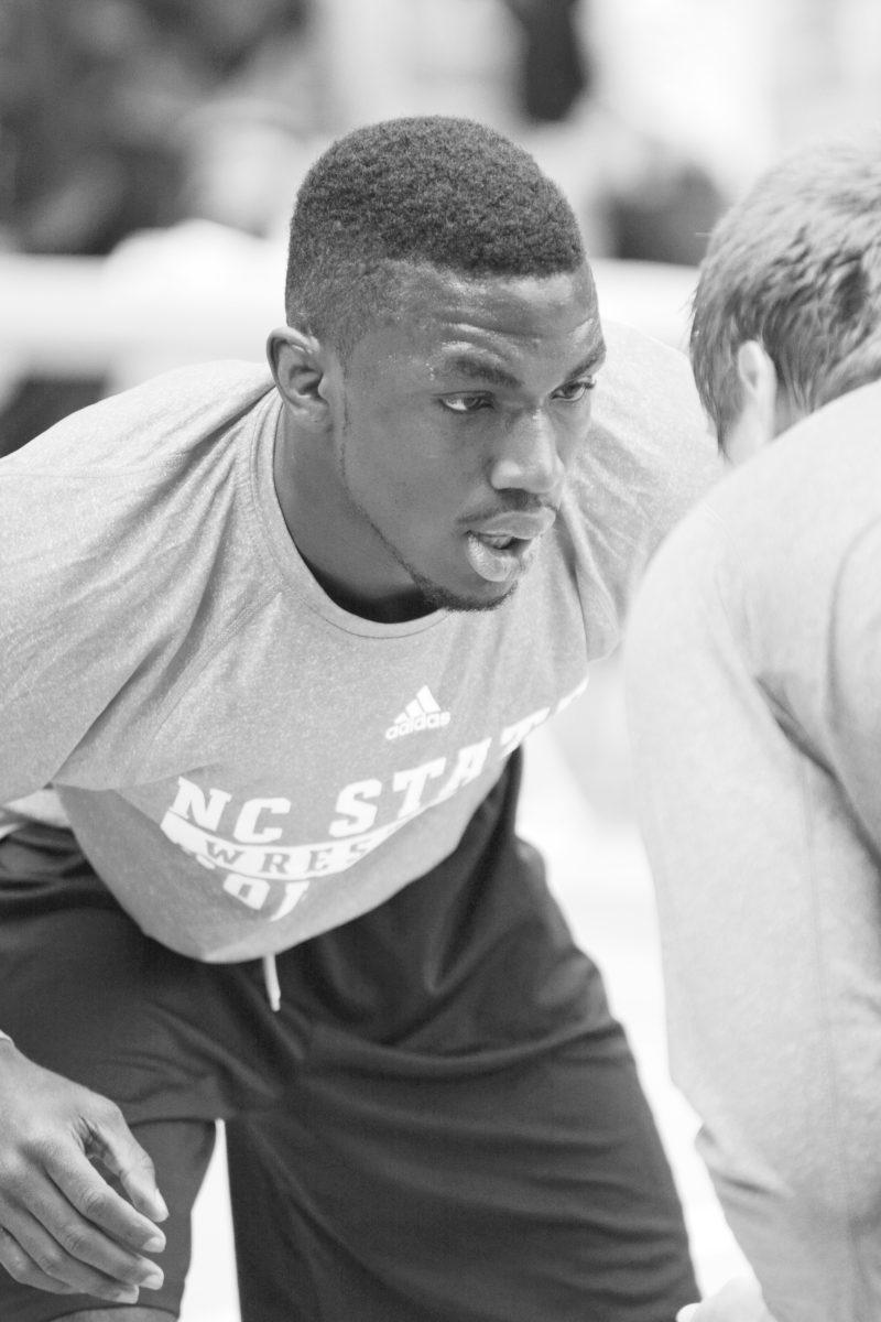 Senior wrestler Nijel Jones makes eye contact with fellow teammate freshman Shayne Brady before attempting to execute a takedown. Photo by Joseph Phillips