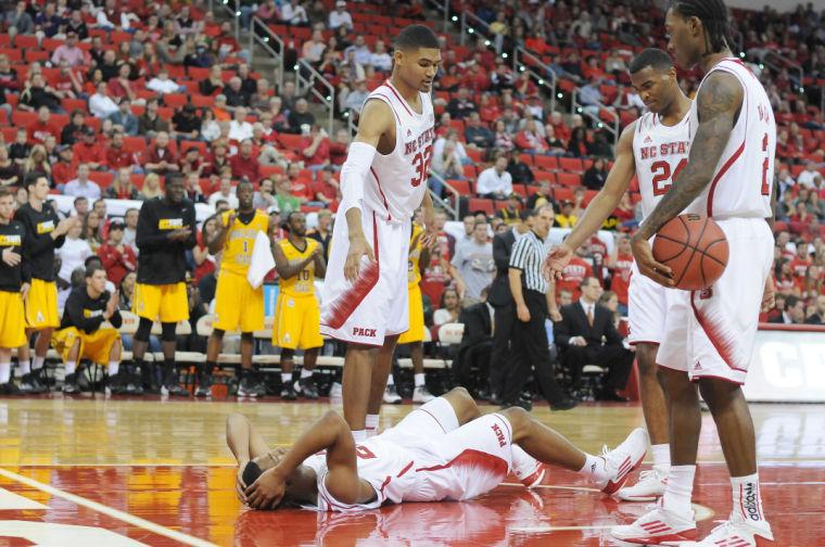 Freshman forward Kyle Washington, sophomore forward T.J. Warren and freshman guard Anthony 'Cat' Barber help redshirt junior Ralston Turner off the ground after being fouled during the game against Appalachian State Friday, Nov. 8, 2013. The Wolfpack defeated the Mountaineers 98-77 at PNC Arena.