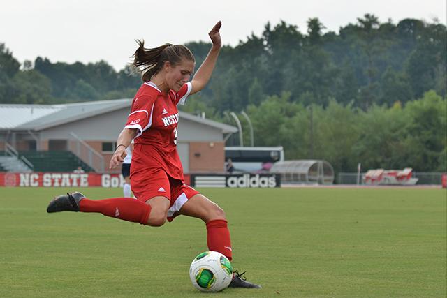 Redshirt senior defender Meagan Proper takes a shot during the soccer match against East Tennessee State University at Dail Soccer Field on Sept. 1, 2013. Proper scored in the Wolfpack's 2-1 win against Wake Forest. Photo by John Joyner.