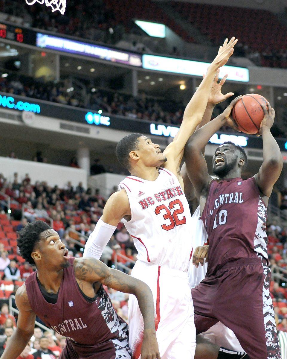 Freshman forward Kyle Washington blocks a shot by N.C. Central's Karamo Jawara Wednesday night. Washington had two points in the Wolfpack's 82-72 loss to the Eagles in overtime at PNC Arena.